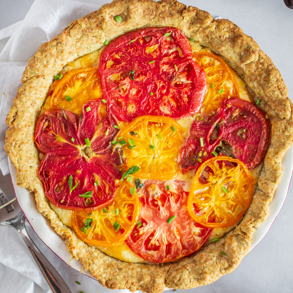 https://www.strawberryblondiekitchen.com/wp-content/uploads/2021/07/Tomato-Pie-with-Cheesy-Herb-Crust-0178-3.jpg